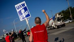 United Auto Workers (UAW) members cheer as cars honk on a picket line outside the Ford Motor Co. Michigan Assembly plant in Wayne, Michigan, US, on Friday, Sept. 15, 2023. The United Auto Workers began an unprecedented strike at all three of the legacy Detroit carmakers, kicking off a potentially costly and protracted showdown over wages and job security. 