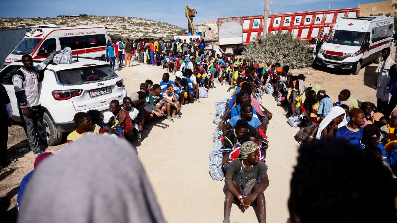 Migrants queue as they wait to be transferred to the mainland on the Sicilian island of Lampedusa on Saturday. 