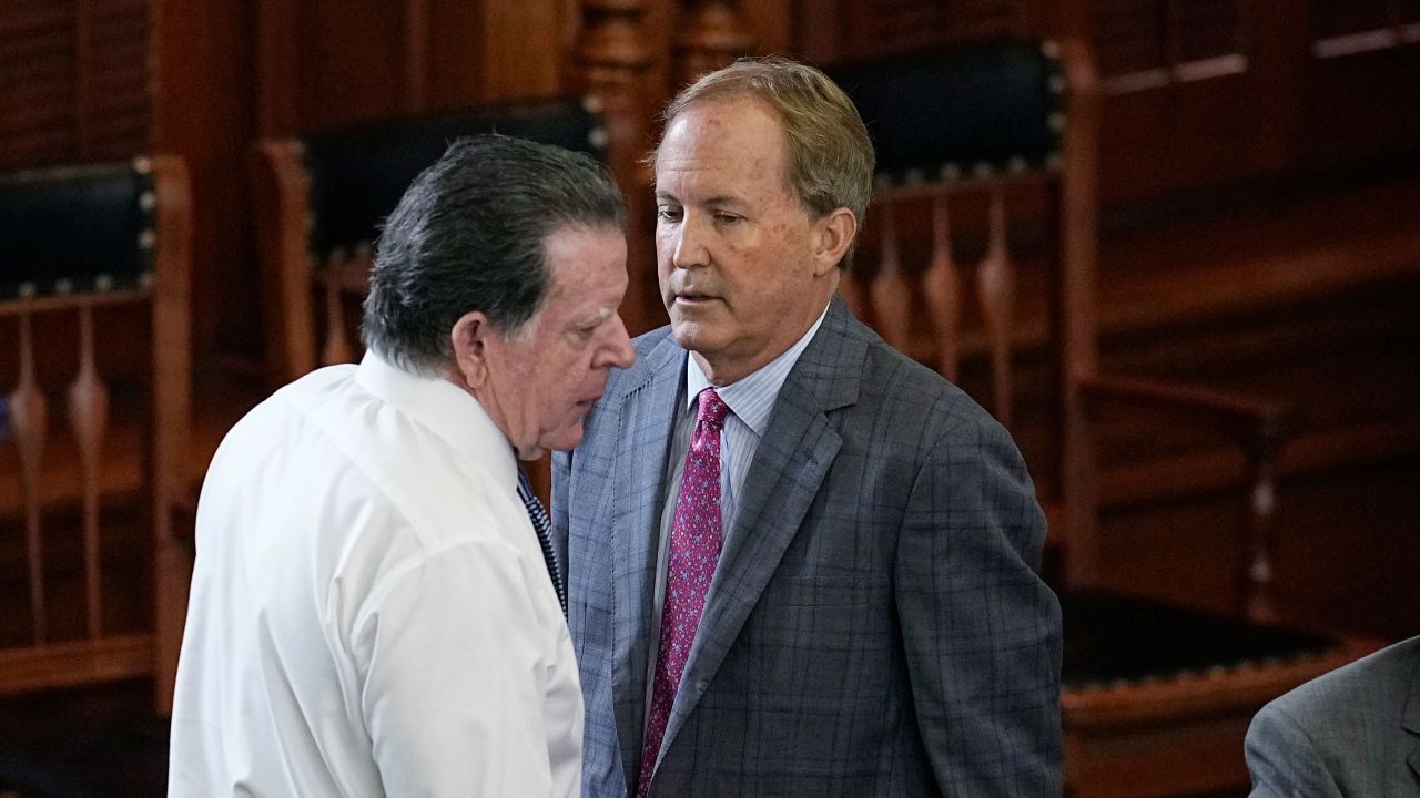 Suspended Texas state Attorney General Ken Paxton, right, talks with his attorney Dan Cogdell, left, during his impeachment trial in the Senate Chamber at the Texas Capitol, Friday, Sept. 15, 2023, in Austin, Texas.