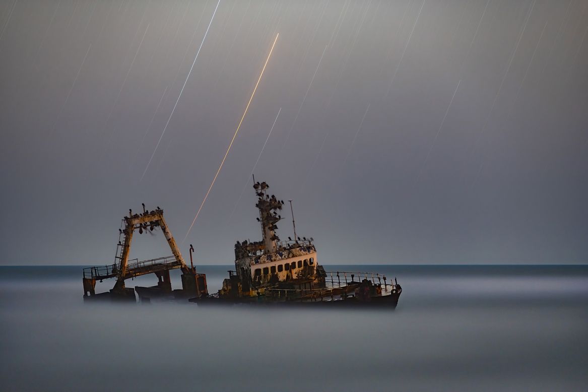 Vikas Chander's photograph of star trails poking through the gray sky above a ship stranded in the treacherous, most northern part of Namibia's Atlantic-facing coast on August 25, 2008, prevailed in the People & Space category.