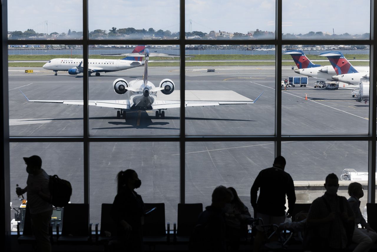 Delta Air Lines planes on the tarmac at Terminal C of LaGuardia Airport (LGA) in New York, U.S., on Monday, Aug. 2, 2021. Citing a surge in unruly passengers, U.S. aviation regulators are calling on the nation's airports to encourage the police to arrest offenders, and to prevent people from sneaking alcohol on board. Photographer: Angus Mordant/Bloomberg via Getty Images