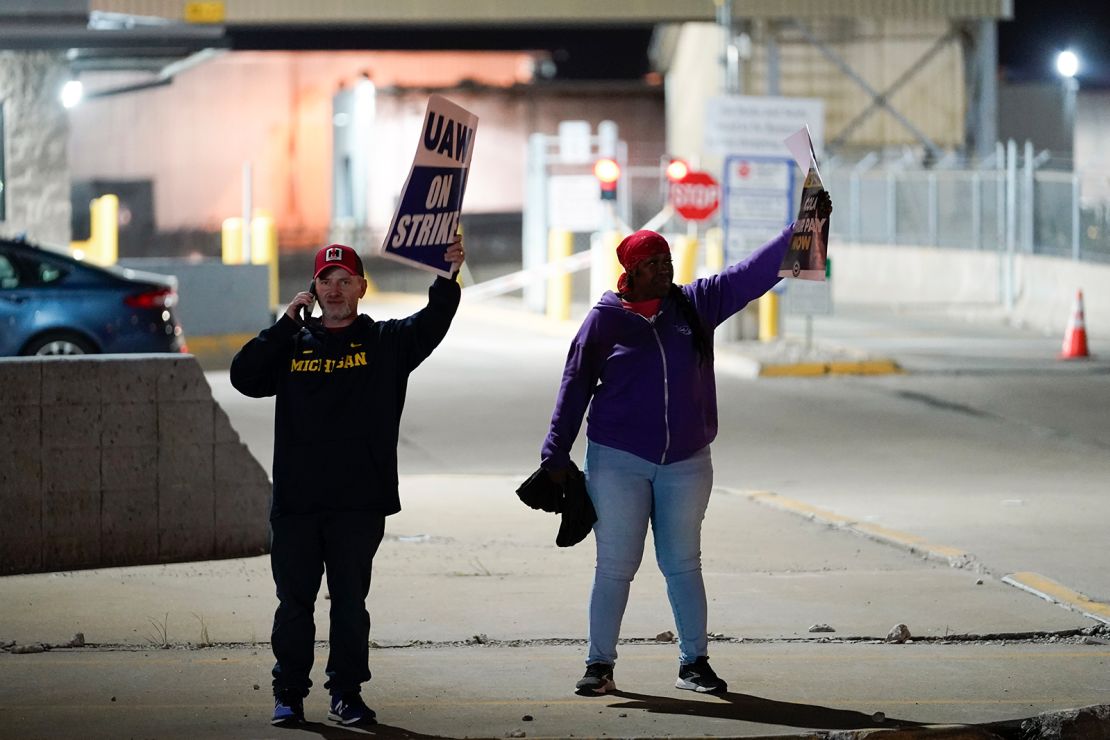 United Auto Workers members Bryan Horvath, left, Ann Hardy picket at Ford's Michigan Assembly Plant in Wayne, Mich., early Friday, Sept. 15, 2023. (AP Photo/Paul Sancya)