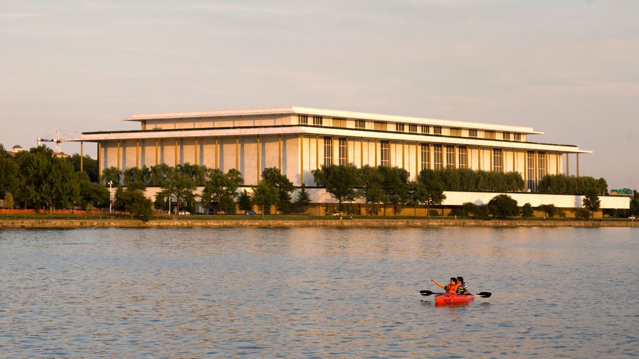 Kayakers on the Potomac River in front of the John F. Kennedy Center for the Performing Arts in Washington, DC.