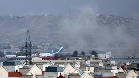 In this August 26, 2021 photo, smoke rises from a deadly explosion outside the airport in Kabul, Afghanistan.