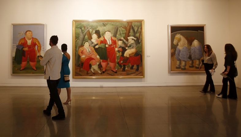 Visitors to the Museum of Antioquia in Medellin take in an exhibition of Botero's work put on to celebrate his 90th birthday in 2022.