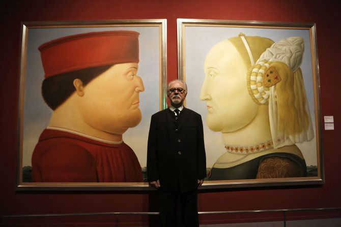 Botero poses with his diptych "After Piero della Francesca" ahead of the opening of his exhibition "Botero in China" at the National Museum of China in Beijing in November 2015. The paintings reimagine two portraits by della Francesca, the famed Renaissance, of a 15th-century Duke of Urbino, Federico da Montefeltro, and his second wife, Battista Sforza. 