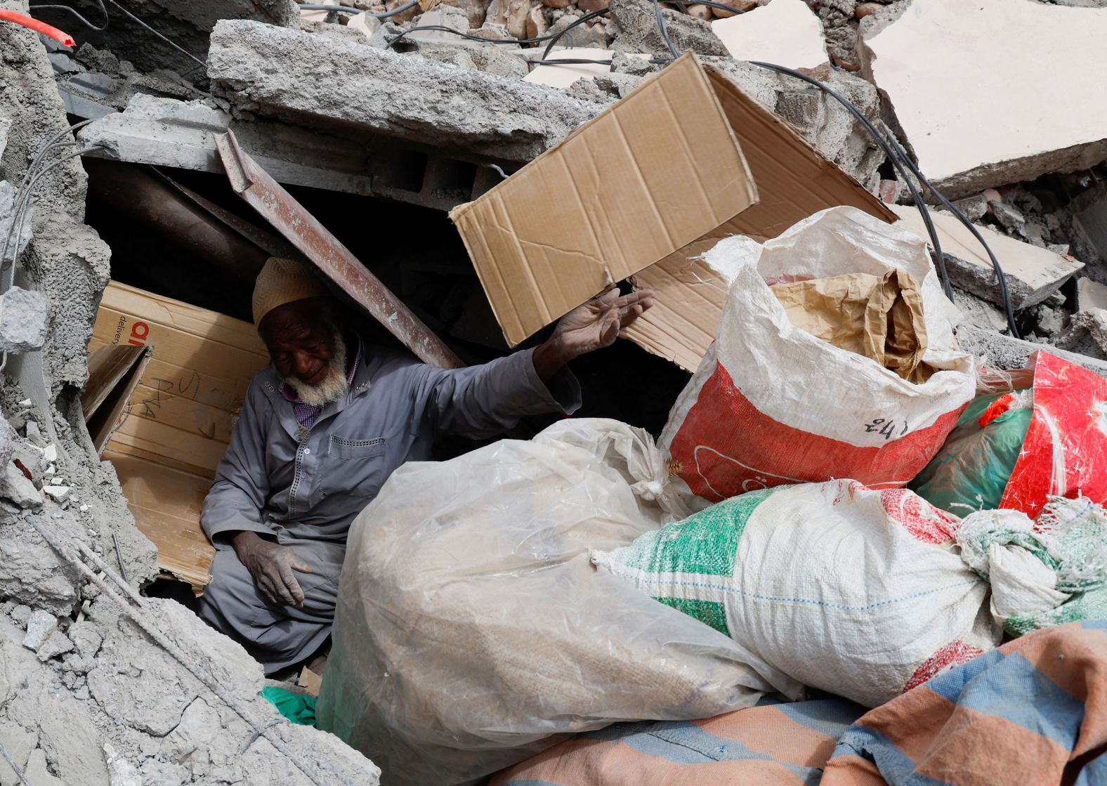 Hammou Baha Ali, 80, searches for his belongings in Talat N'Yaaqoub on September 15.