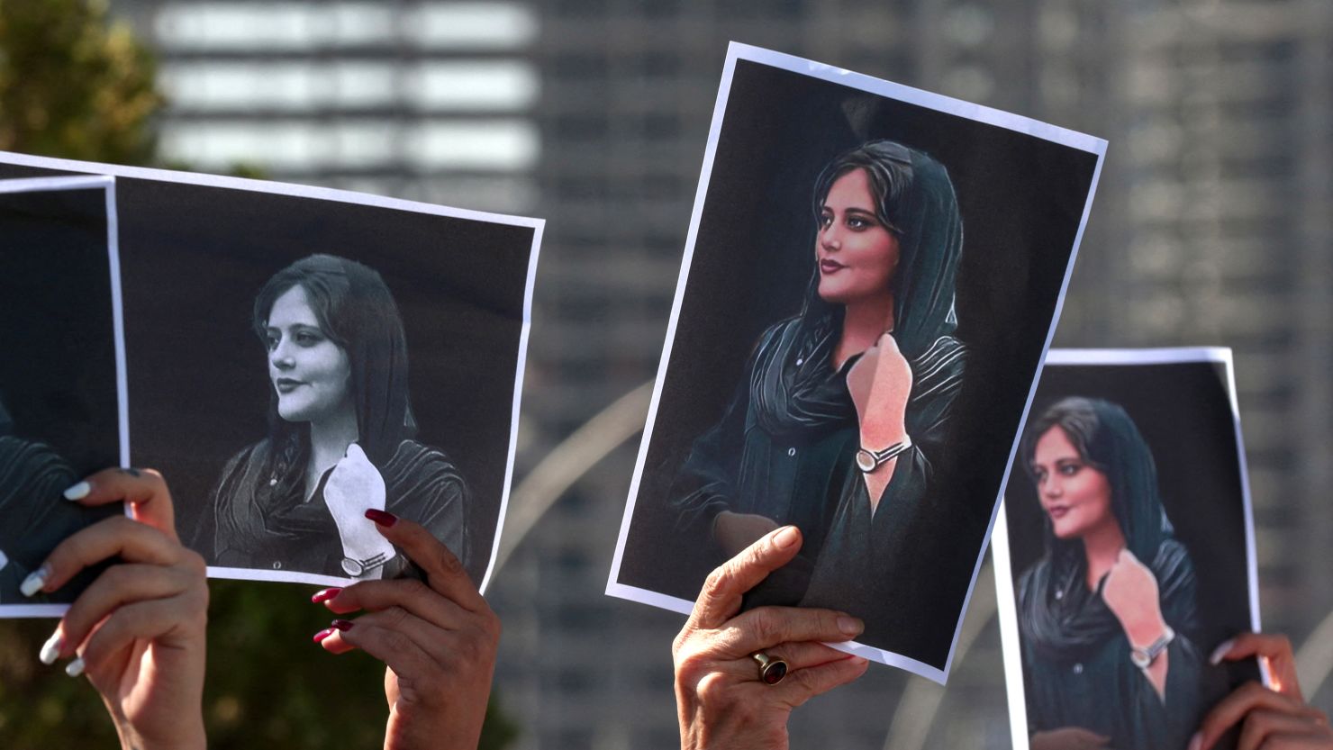 Women hold up signs depicting the image of 22-year-old Mahsa Amini, who died while in the custody of Iranian authorities, during a demonstration denouncing her death by Iraqi and Iranian Kurds outside the UN offices in Arbil, the capital of Iraq's autonomous Kurdistan region, on September 24, 2022. Angry demonstrators have taken to the streets of major cities across Iran, including the capital Tehran, for eight straight nights since the death of 22-year-old Mahsa Amini. The Kurdish woman was pronounced dead after spending three days in a coma following her arrest by Iran's feared morality police for wearing the hijab headscarf in an 