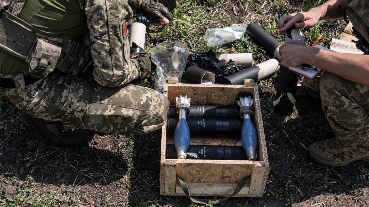 Ukrainian soldiers prepare mortar shells during military training.