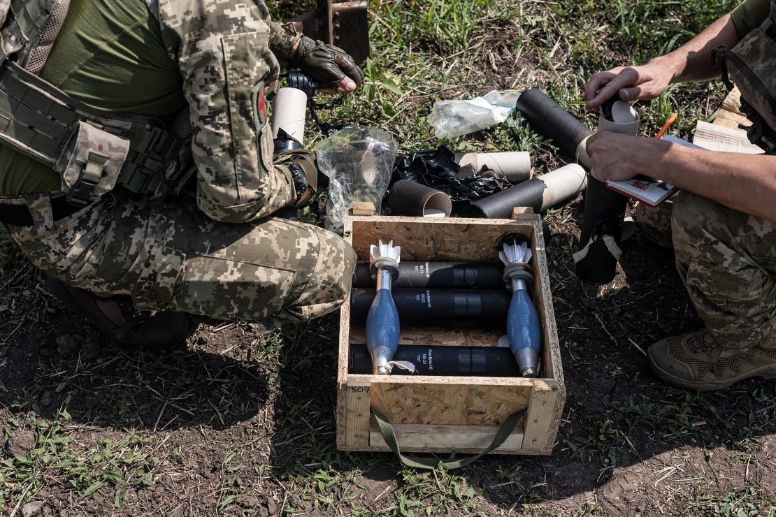 Ukrainian soldiers prepare mortar shells during military training.