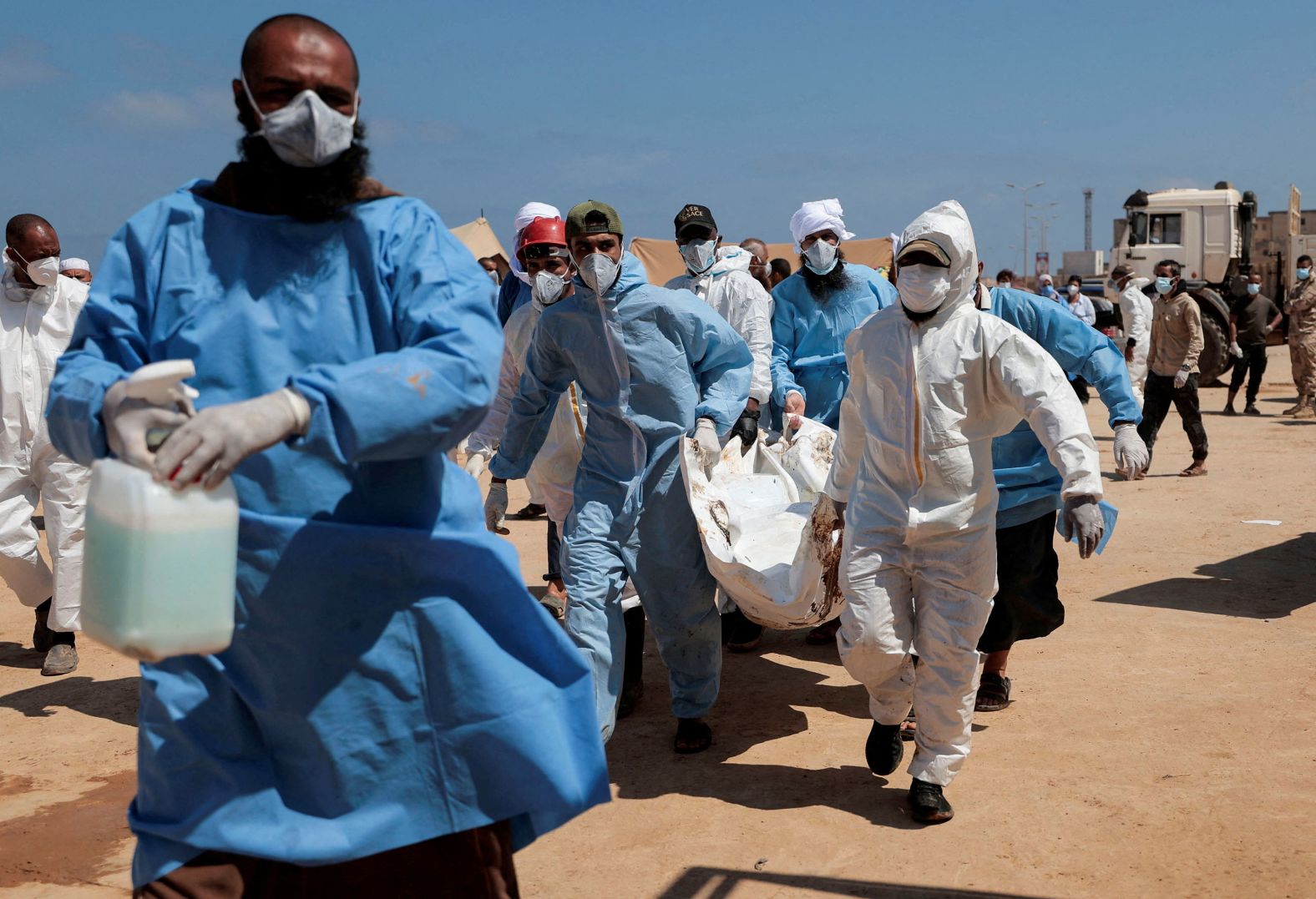 Volunteers carry a body to a truck in Derna on September 16.