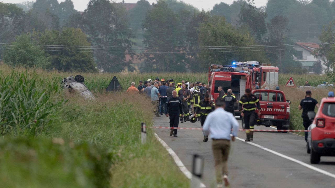 The debris of a burnt car, left, as firefighters seal off the area where an aircraft of the Italian acrobatic air team the Frecce Tricolori crashed during a practice run outside the northern city of Turin on Sept. 16.
