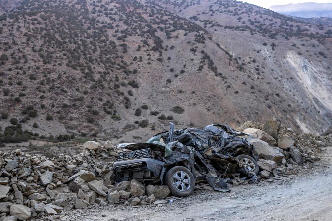 A crushed car is buried in rubble by the side of the road between Marrakech and Taroudant on September 16.