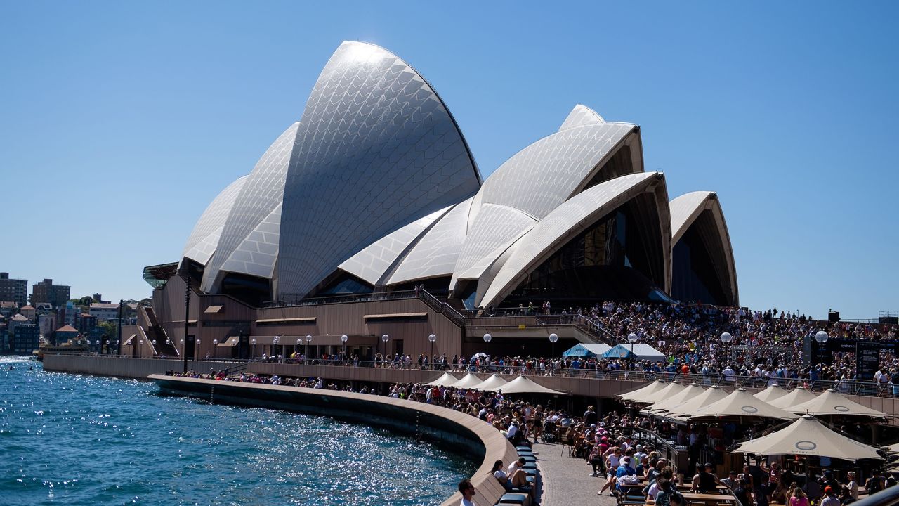 A big crowd gathered in the sun at the Opera House to watch the finish of the Sydney Marathon 