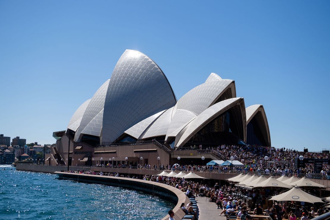 A big crowd gathered in the sun at the Opera House to watch the finish of the Sydney Marathon 