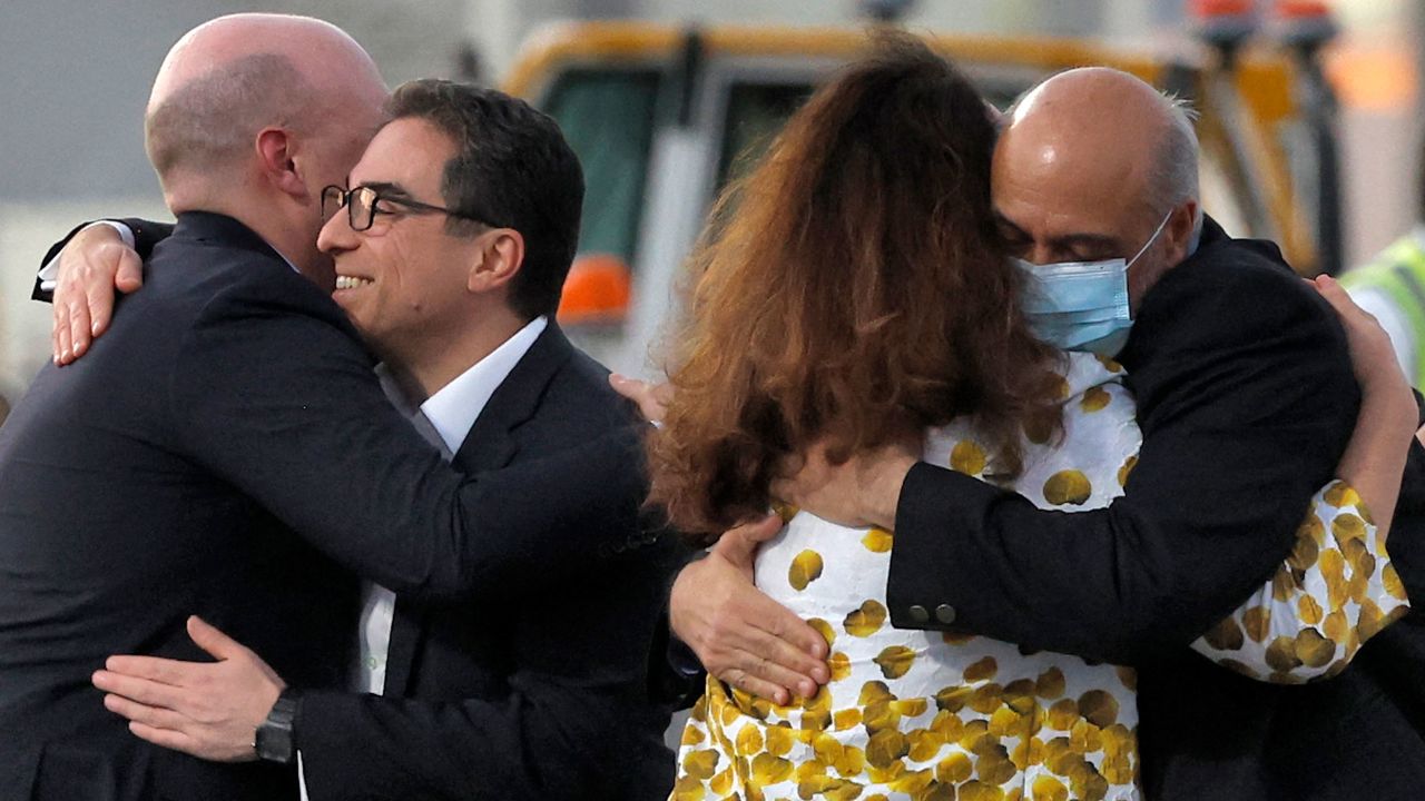 US citizens Siamak Namazi (2nd-L) and Morad Tahbaz (R) are welcomed by people upon disembarking from a Qatari jet upon their arrival at the Doha International Airport in Doha on September 18, 2023. Five US detainees, three previously identified as Siamak Namazi, Morad Tahbaz and Emad Sharqi and two who wish to remain anonymous, released by Iran landed in Doha in a prisoner swap on September 18 after $6 billion in frozen funds were transferred to Iranian accounts in Qatar. (Photo by AFP) (Photo by -/AFP via Getty Images)