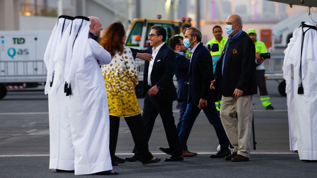 US citizens Siamak Namazi (C-with glasses), Emad Sharqi (2R) and Morad Tahbaz (R) are greeted upon their arrival at the Doha International Airport in Doha on September 18, 2023. Five US detainees, three previously identified as Siamak Namazi, Morad Tahbaz and Emad Sharqi and two who wish to remain anonymous, released by Iran landed in Doha in a prisoner swap on September 18 after $6 billion in frozen funds were transferred to Iranian accounts in Qatar. (Photo by Karim JAAFAR / AFP) (Photo by KARIM JAAFAR/AFP via Getty Images)