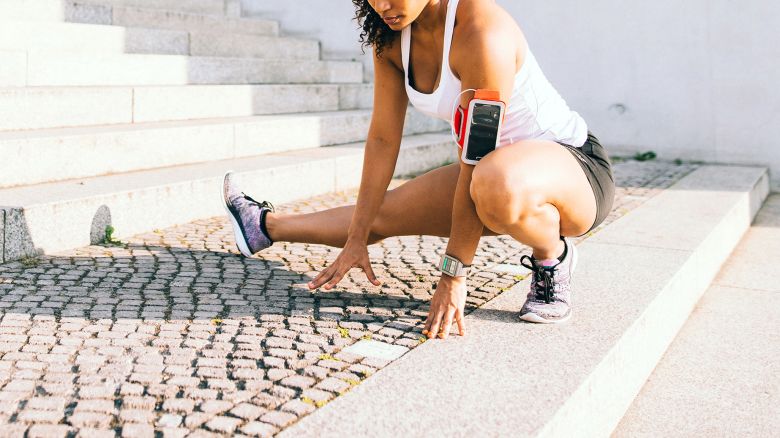 Woman doing stretching after running in the city.