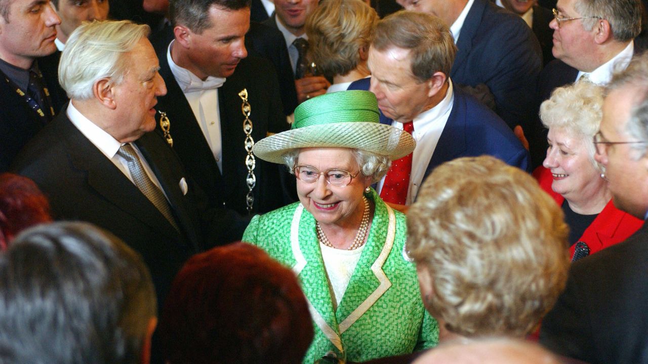 Queen Elizabeth II greets politicians with French Senate Speaker Christian Poncelet, left, in Paris in 2004.