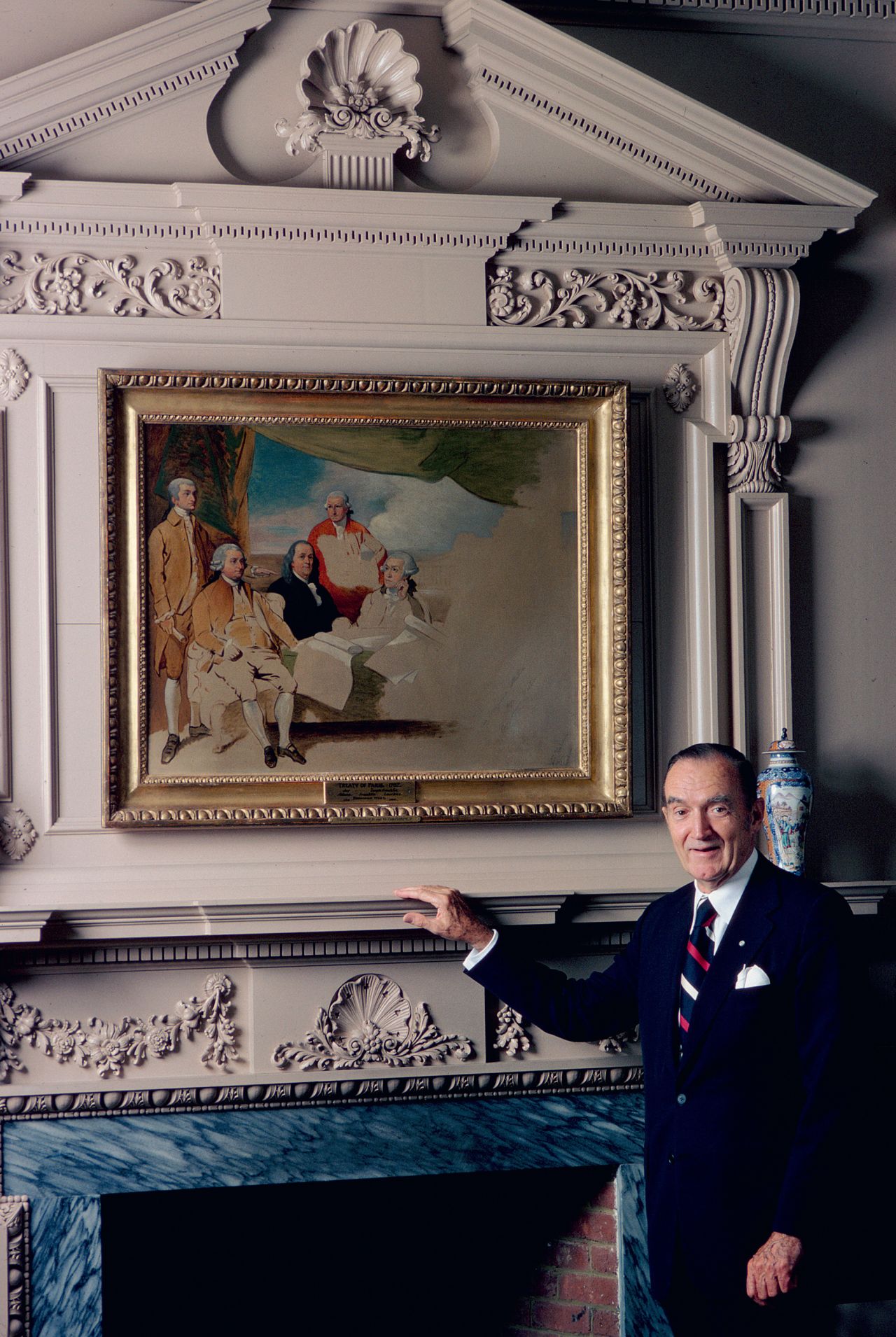 Clement Conger pictured with a copy of painter Benjamin West's circa-1820 unfinished work "The American commissioners of the preliminary peace negotiations with Great Britain." From left, featured in the painting are John Jay, John Adams, Benjamin Franklin, Henry Laurens and William Temple Franklin.