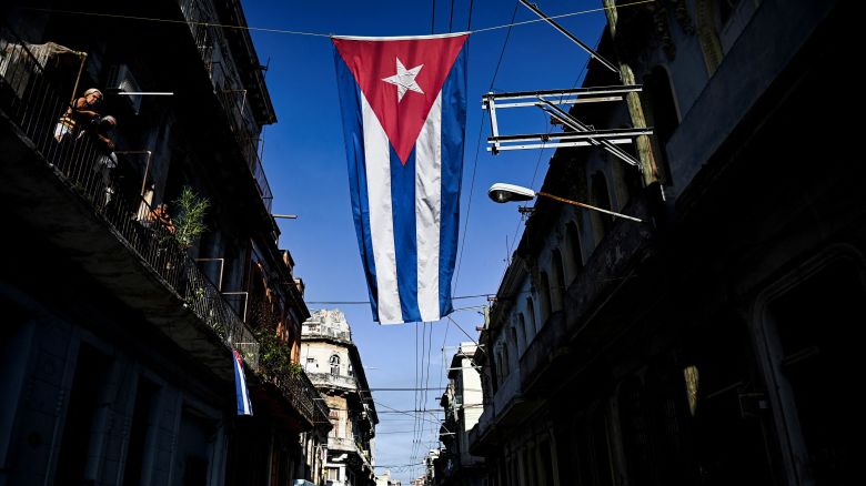 A Cuban flag hangs in a street of Havana.