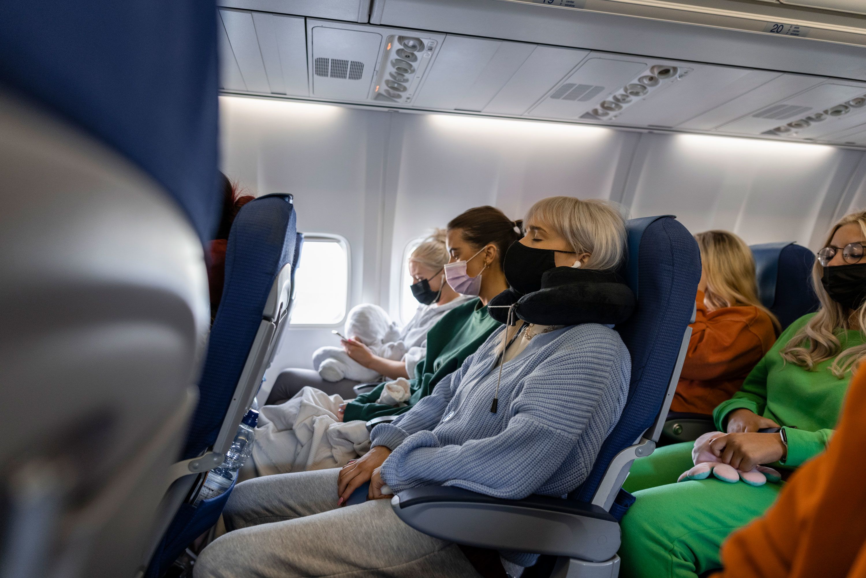 How to sleep comfortably on a plane, from short to long-haul flights - The  Points Guy