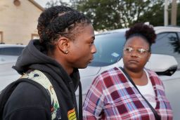 Darryl George, left, a 17-year-old junior, and his mother Darresha George, right, speak to reporters before school starts at Barbers Hill High School. 