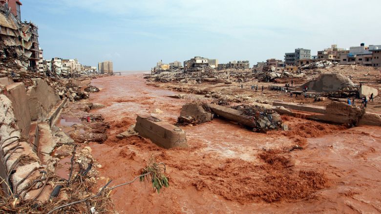 TOPSHOT - People look at the damage caused by freak floods in Derna, eastern Libya, on September 11, 2023. Flash floods in eastern Libya killed more than 2,300 people in the Mediterranean coastal city of Derna alone, the emergency services of the Tripoli-based government said on September 12. (Photo by AFP) (Photo by -/AFP via Getty Images)
