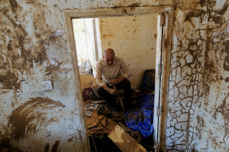 Hassan Kassar, who lost his daughters, two of his sons and his granddaughter, sits inside his damaged house in Derna on Sunday, September 17.