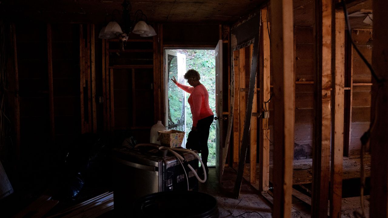 Christine White walks through her flood-damaged house in Lost Creek, Kentucky, on September 29, 2022. - Chase Hays is "torn": after seeing floods ravage his hamlet in the Appalachian mountains, he filed a complaint against the mine that overlooks it, but this 34-year-old American does not want to be perceived as an "enemy" of coal. Like him, people in eastern Kentucky are struggling to challenge an industry that has long offered the only well-paying jobs in the region. And in the run-up to the midterm elections, few candidates dare to talk to them about climate change.