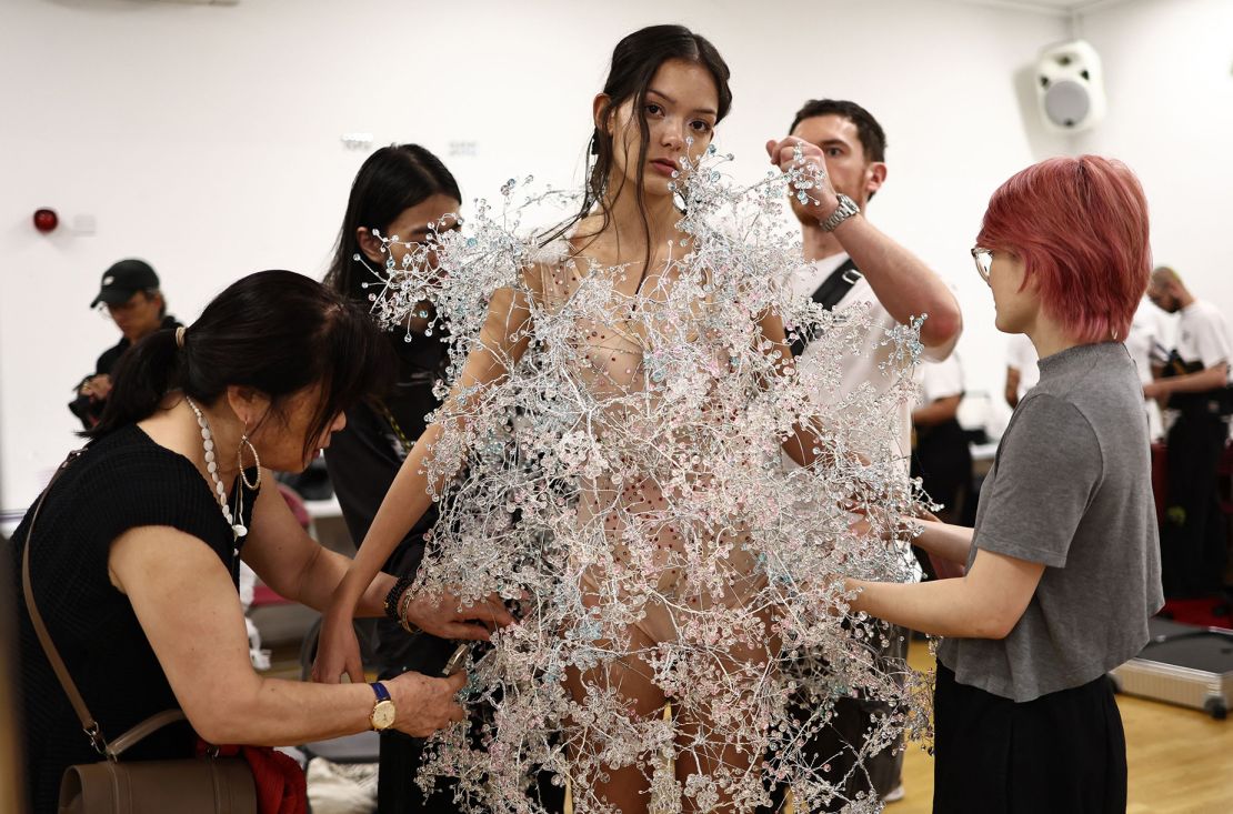 Models pose for pictures and have their final preparations made backstage ahead of a catwalk presentation for designer Susan Fang's Spring/Summer 2024 collection, at London Fashion Week in London, on September 17, 2023. (Photo by HENRY NICHOLLS / AFP) (Photo by HENRY NICHOLLS/AFP via Getty Images)
