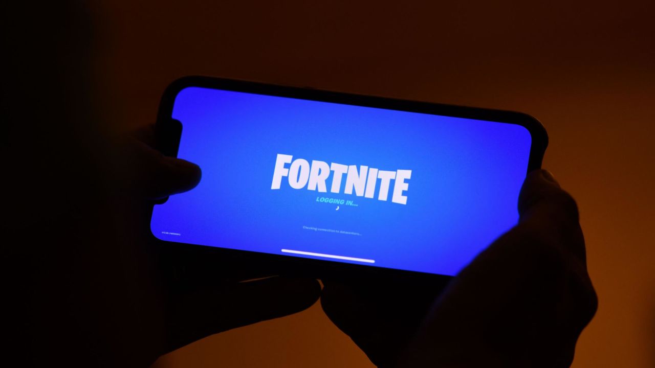 This illustration picture shows a person logging into Epic Games' Fortnite on their smartphone in Los Angeles on August 14, 2020. (Photo by CHRIS DELMAS/AFP via Getty Images)