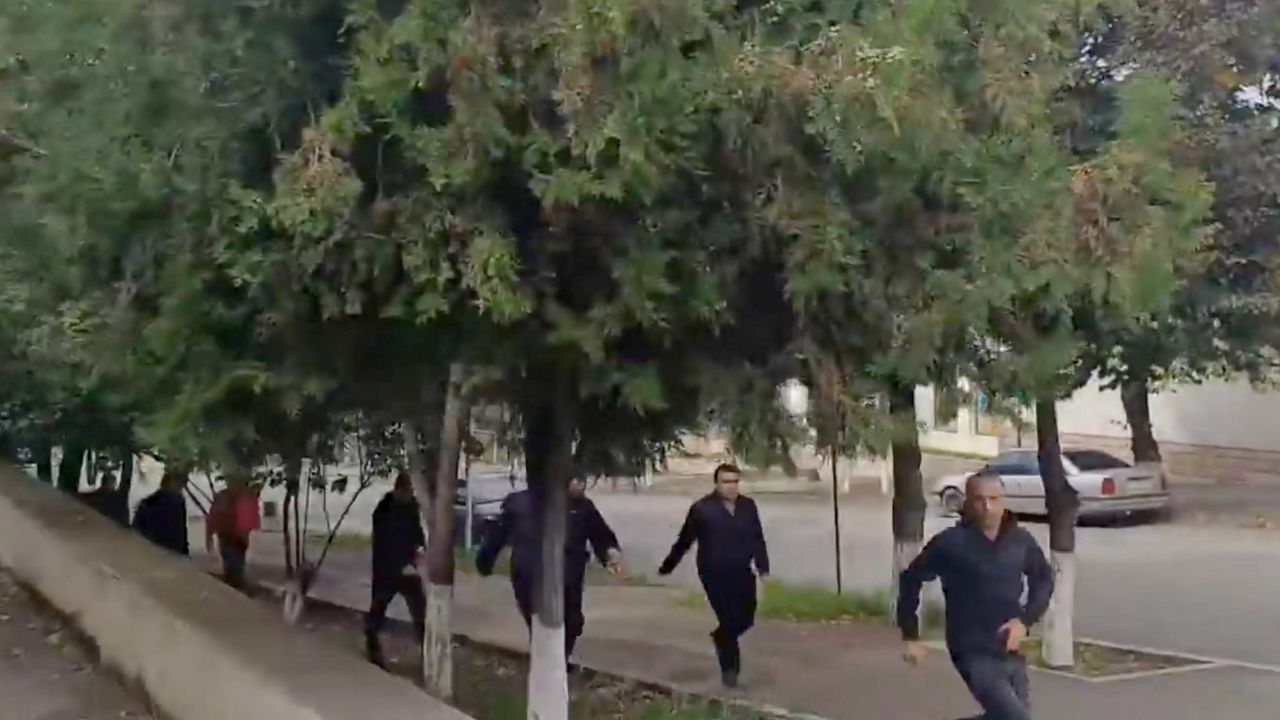 People run as gunfire and explosions are heard in Stepanakert, in the Nagorno-Karabakh region, in this screengrab obtained from a handout video.