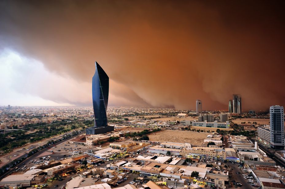 Sarah Hasan Al-Sayegh describes herself as the first female Kuwaiti-Arab storm chaser. Pictured, a "haboob" or dust wall looms dark and red over