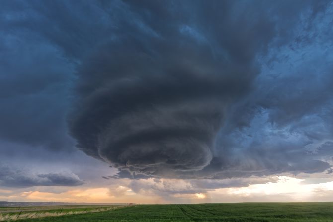 Al-Sayegh captures photographs of storms around the world. Here, a supercell cloud formation twists ominously above fields in Nebraska, 2018.