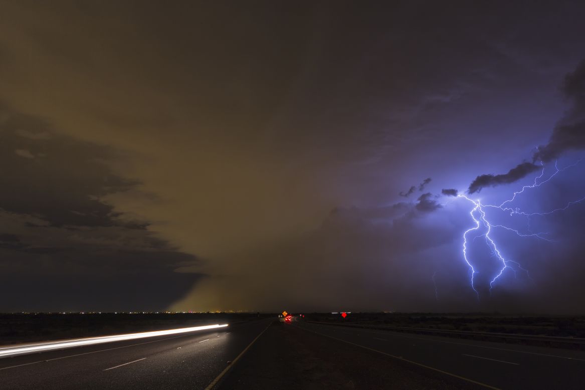 Al-Sayegh, hopes that other Arab women will see her images and feel empowered to take up storm chasing. Here, a Haboob with lightning illuminates a dark road in Phoenix, Arizona, 2015.