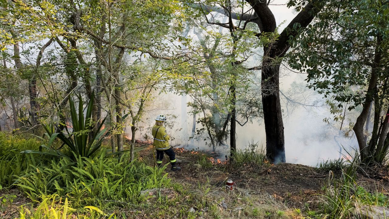 A firefighter monitors a hazard reduction burn in Sydney, Australia. 