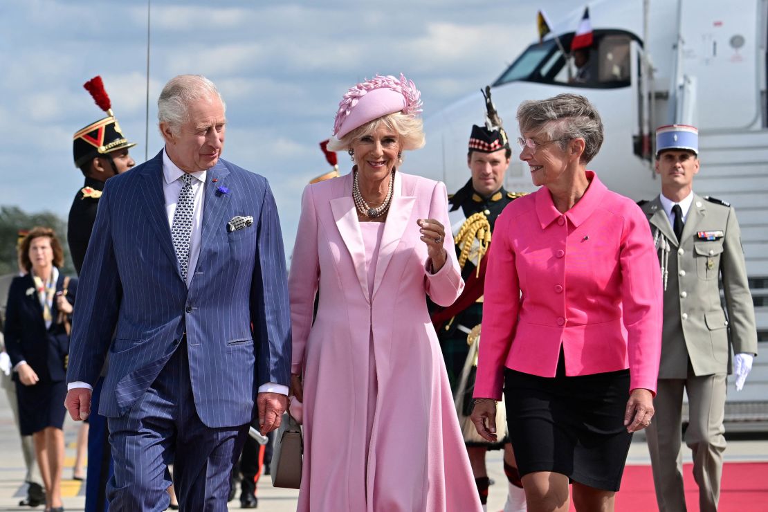 The royal couple were met upon arrival at Paris' Orly Airport by French Prime Minister Elisabeth Borne, right. 