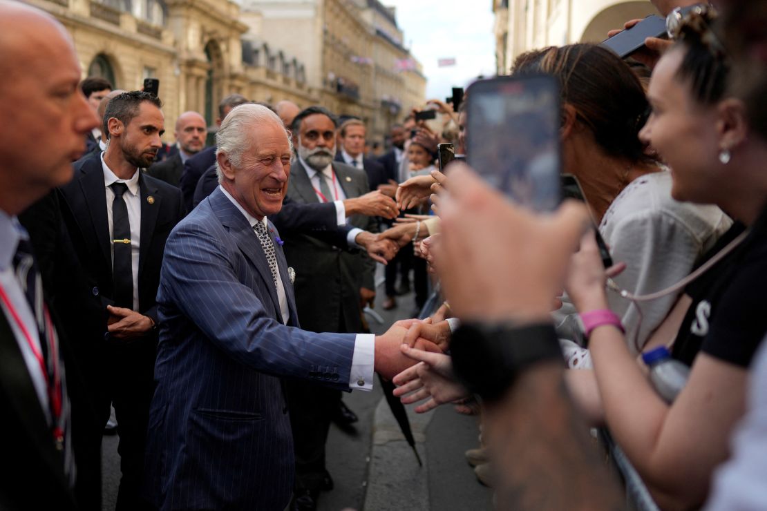 The King delighted members of the French public during a walk from the Elysee Palace to the British ambassador to France's residence on Wednesday afternoon. 