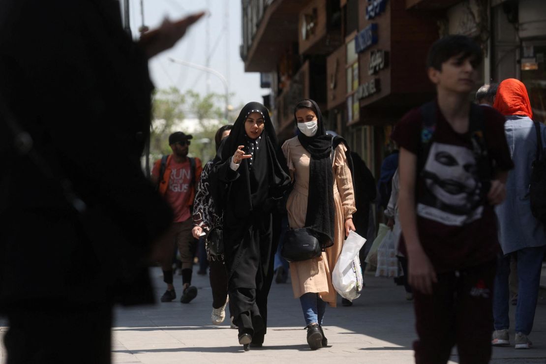 Women walk on the street in Tehran on April 15, 2023. On Thursday, the Iranian parliament passed a controversial bill ramping up penalties against women who do not wear the hijab properly.