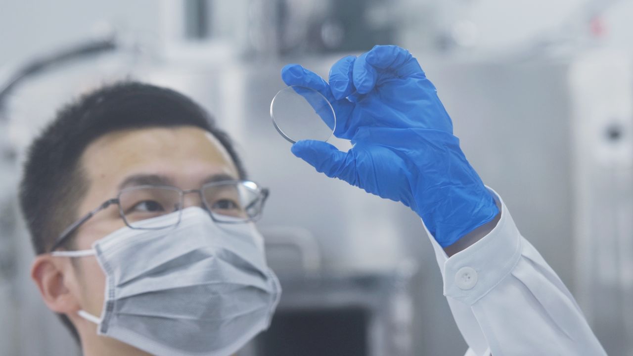 A researcher at China's Zhejiang University Hangzhou International Science and Innovation Center looks at gallium oxide wafers on May 30, 2022.