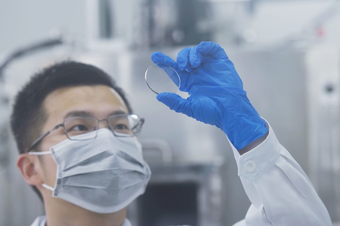 A researcher at China's Zhejiang University Hangzhou International Science and Innovation Center looks at gallium oxide wafers on May 30, 2022.