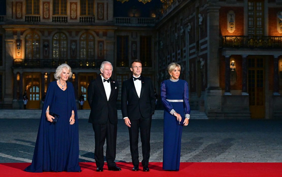 Queen Camilla and King Charles III are welcomed by French President Emmanuel Macron and Brigitte Macron to a state dinner in Versailles on September 20, 2023. 