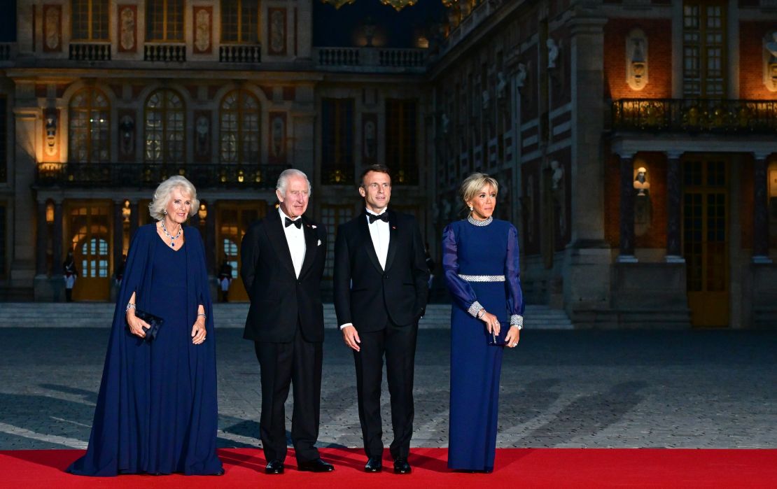 Queen Camilla and King Charles III are welcomed by French President Emmanuel Macron and Brigitte Macron to a state dinner in Versailles on September 20, 2023.