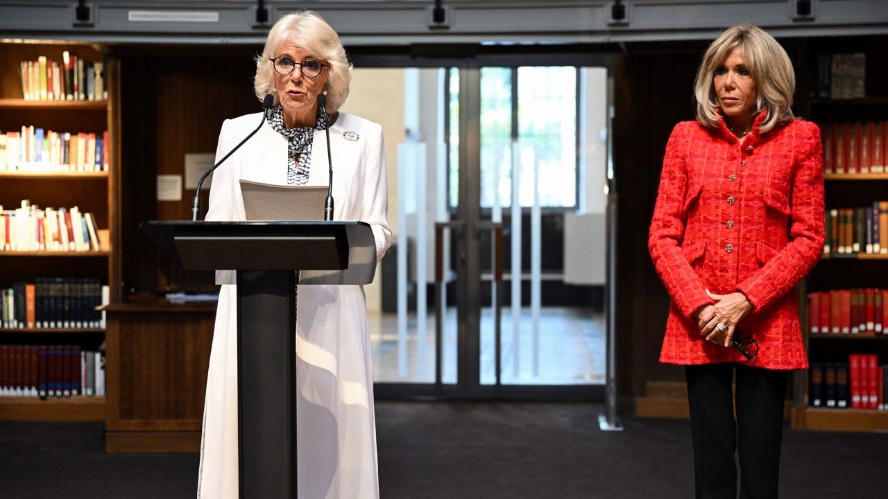 Queen Camilla delivers a speech next to French President‍‍`s wife Brigitte Macron at the national library in Paris. 