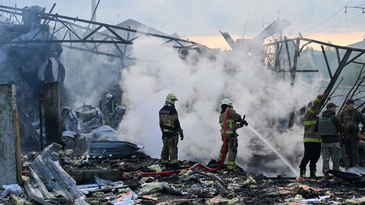 Firefighters put out a fire after an overnight missile attack in Kyiv.