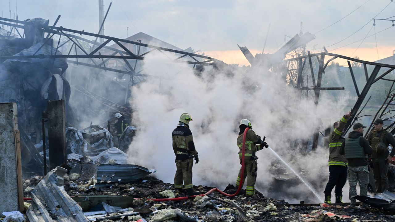 Firefighters are seen after a massive overnight missile attack to Ukraine on September 21.