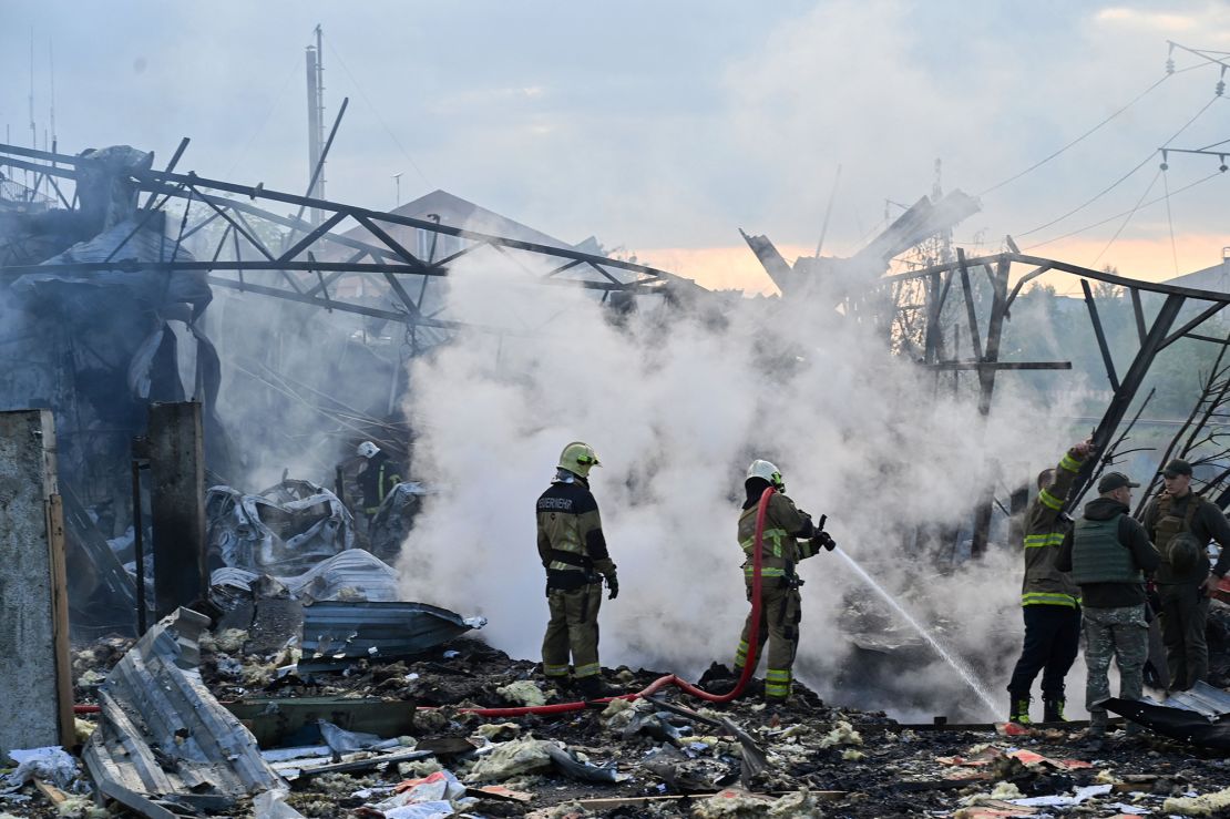 Firefighters are seen after a massive overnight missile attack to Ukraine on September 21.
