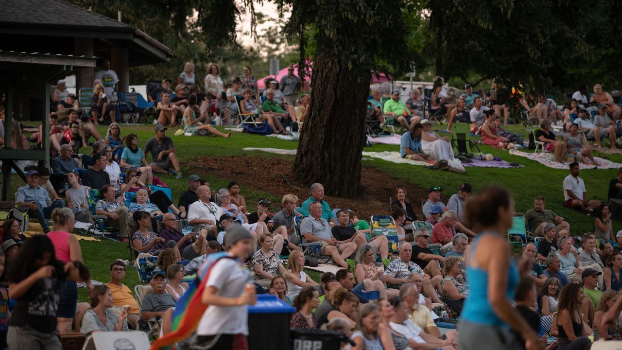 People watch an outdoor concert at Stewart Park in Roseburg.