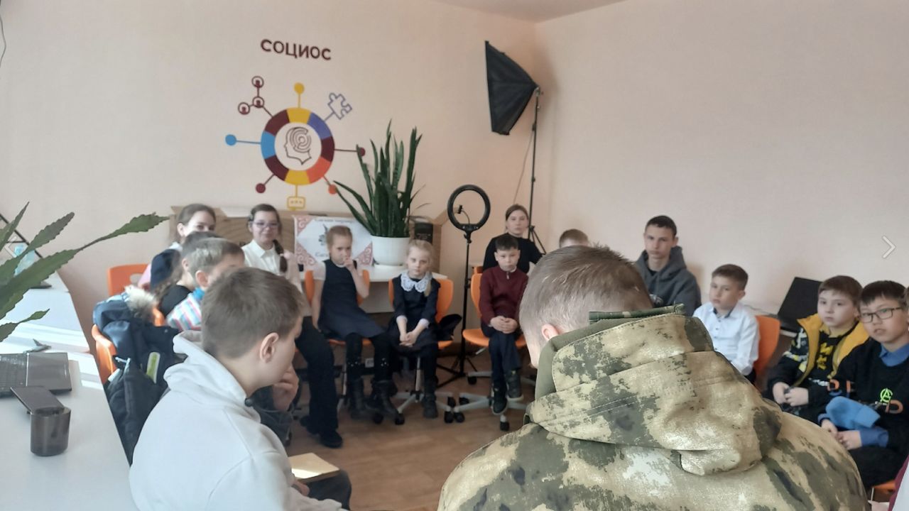 School children are given a talk by a soldier from Russia's army. 